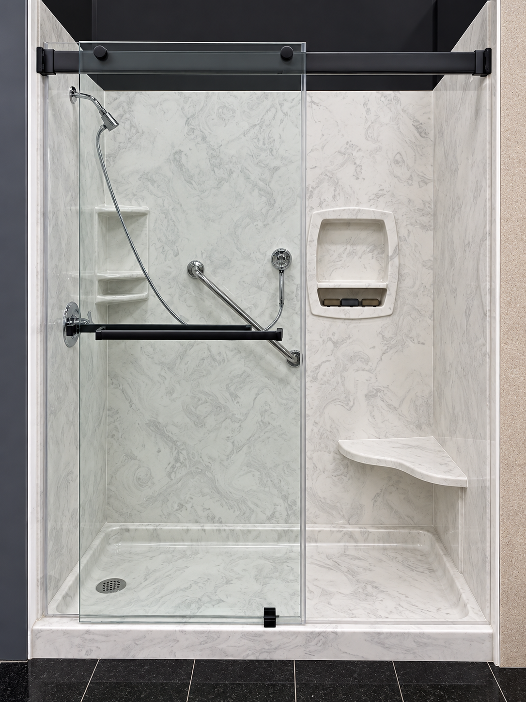 Marble-look shower with glass doors and corner seat